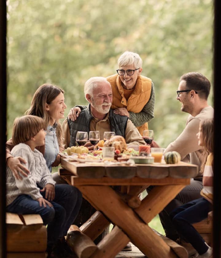 Family gathering eating outside