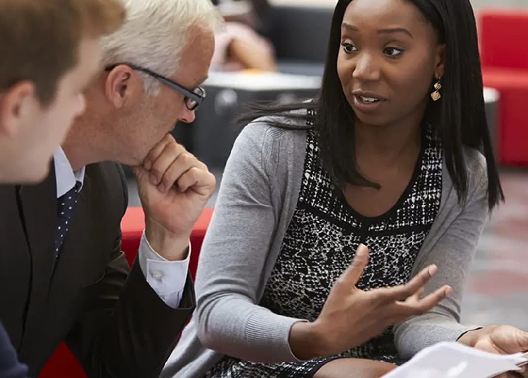 Image - Woman discussing with team