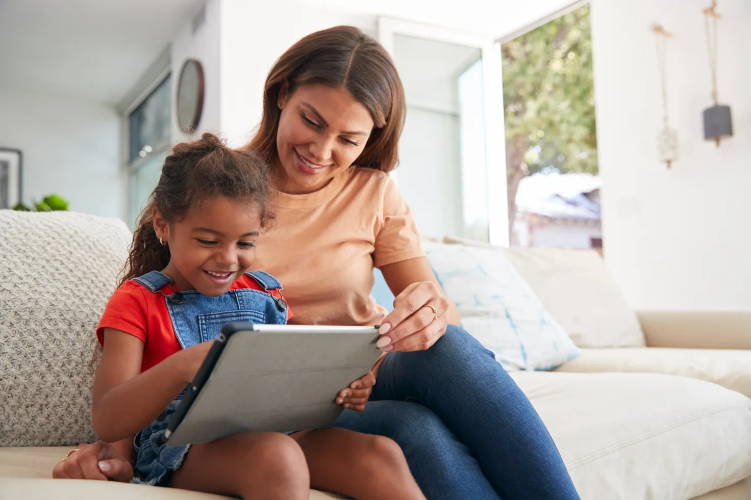 Mother and daughter playing on the ipad