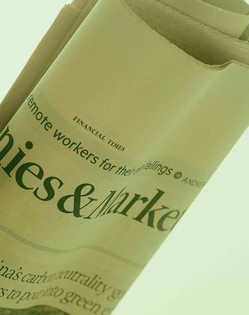 Close up of a rolled up financial newspaper