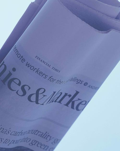 Close up of a rolled up financial newspaper