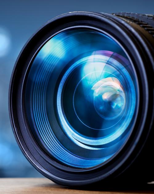 Image of blue iridescent camera lens on a blue background 